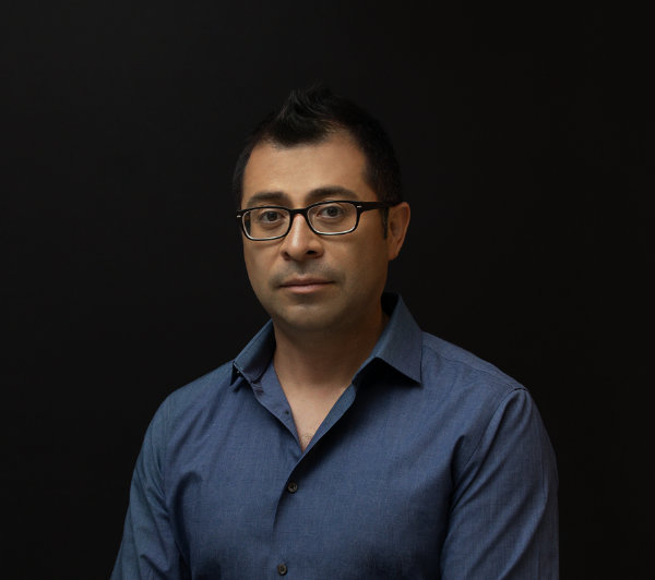 photo of the author, Luis Paredes holding a book